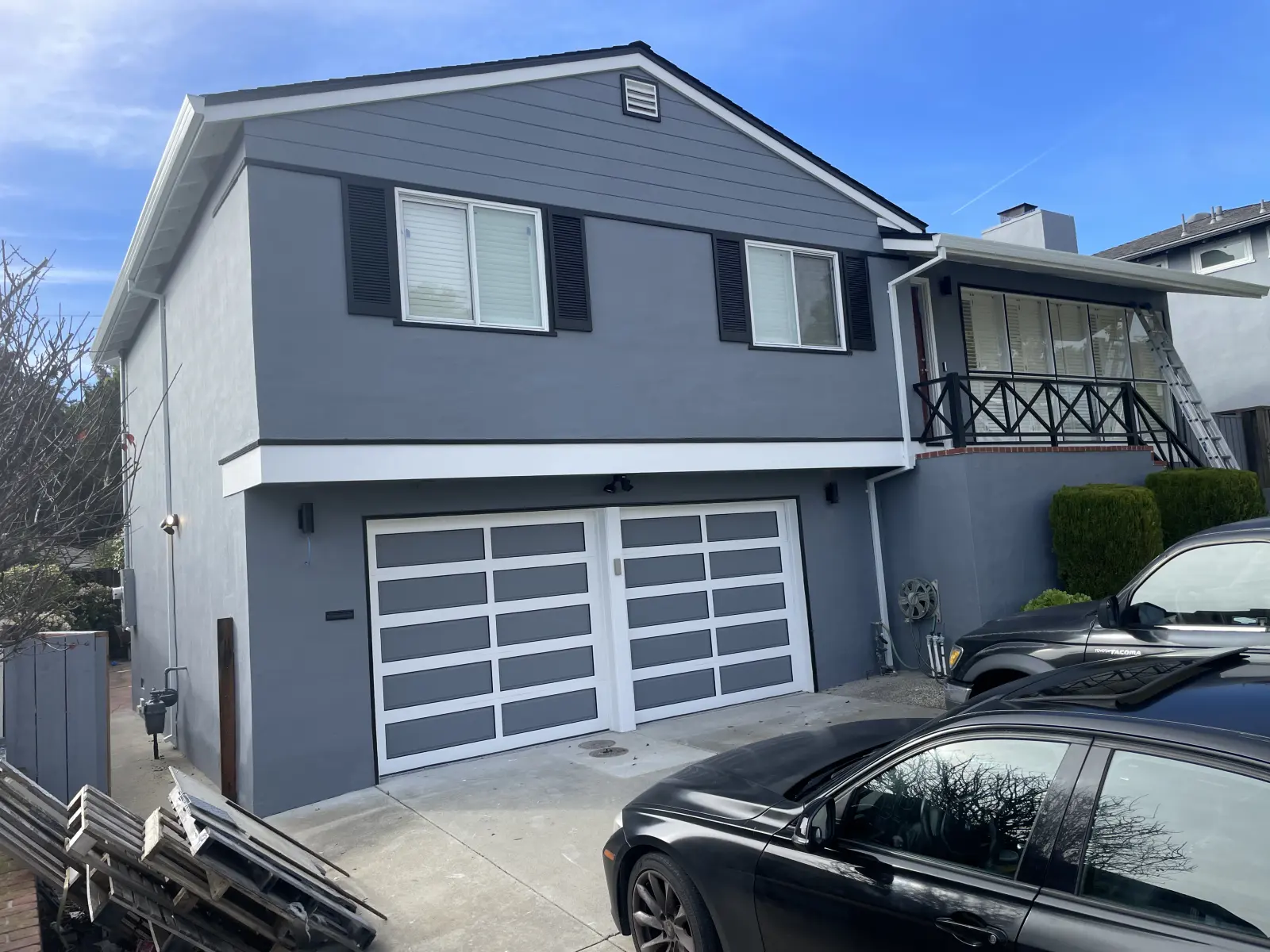 The same grey house seen from the street