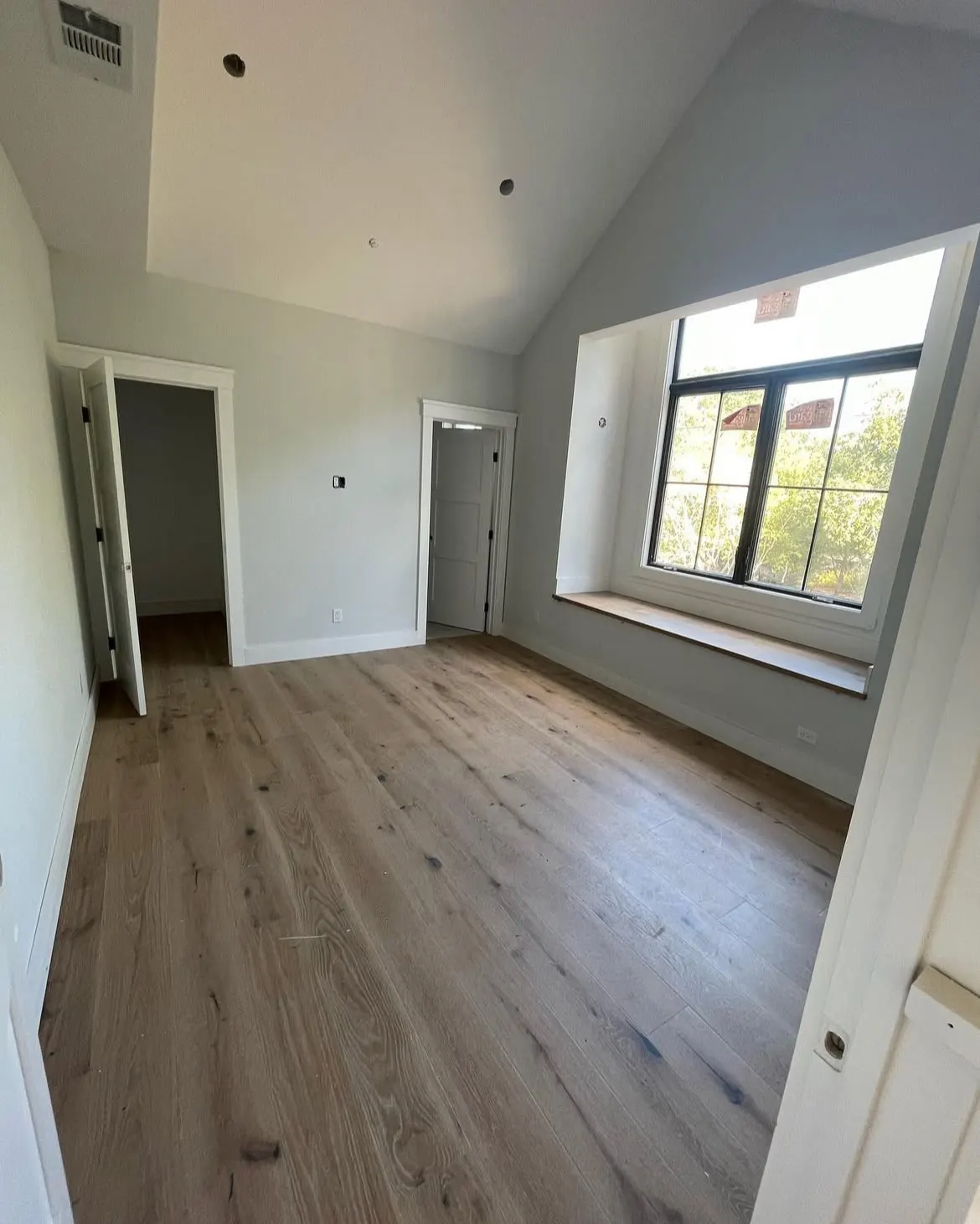 Bedroom with white walls and a large window