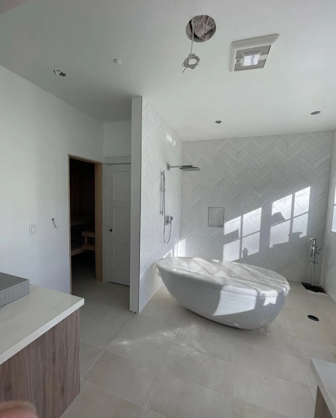 Bathroom with a walk-in shower and white walls